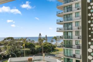 a view of a building with the ocean in the background at Sakara at Marochydore in Maroochydore