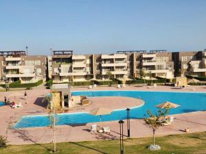 a large swimming pool in front of some apartment buildings at Marina Blu Blumar Chalet in Ain Sokhna