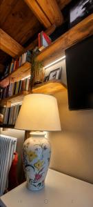 a lamp sitting on a table in a room at Enfin Clavon - appartamento in baita in Verrayes +9 photos