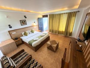 a large bedroom with a bed and a couch at Silver Green Resort in Wayanad