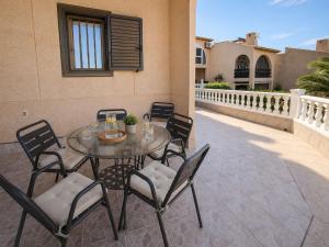 a table and chairs sitting on a patio at Chalet a orillas del mar in Torrevieja