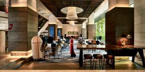 a restaurant with tables and chairs in a building at Pan Pacific Hanoi in Hanoi