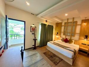 a bedroom with a large bed and a large window at Silver Green Resort in Wayanad +118 photos