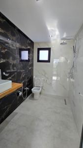 a bathroom with a toilet and a sink at Pool House et Rooftop Hammamet in Dar Hamad Jedidi +18 photos