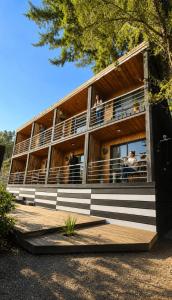 a building with people on the balconies of it at Lodge Los Bosques in Matanzas
