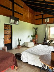 a bedroom with a large bed and a table at Centro Holístico Kinam in Amecameca de Juárez