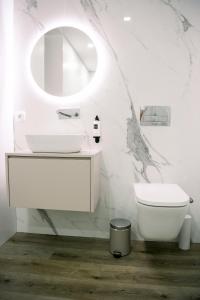 a white bathroom with a sink and a toilet at 3Encostas in Cabeceiras de Basto +16 photos