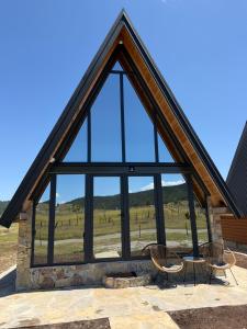 a large window on a house with a view of a field at Hedwig cottages 2 in Žabljak