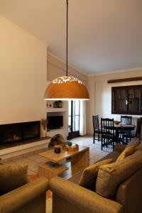 a living room with a couch and a table at TheA Upper Blue in Kyparissia