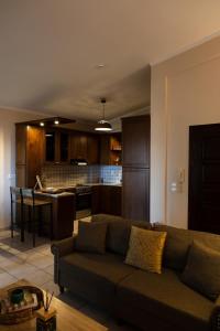 a living room with a couch and a kitchen at TheA Upper Blue in Kyparissia
