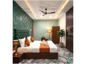 a bedroom with a bed and a ceiling fan at Hotel Prime Access Inn in Indore