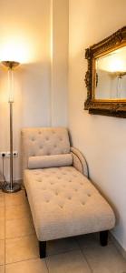 a chair in a room with a mirror and a lamp at TheA Upper Blue in Kyparissia +22 photos