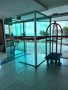 a glass building with a cage in the middle at Flat com vista para o mar - apto 1605 in Natal