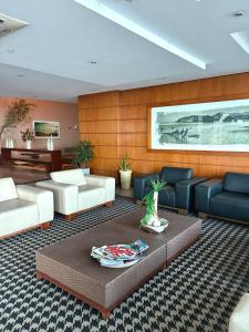 a living room with couches and a coffee table at Flat com vista para o mar - apto 1605 in Natal +27 photos