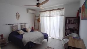 a bedroom with a bed and a window at Villa Hill-Sea in Saint Martin +16 photos