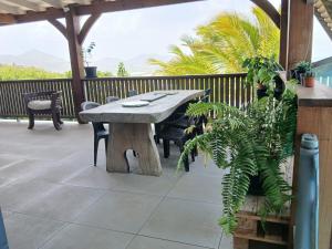a wooden table and chairs on a patio at Villa Hill-Sea in Saint Martin