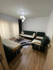 a living room with two beds and a couch at Gashi Home in Prizren