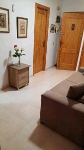 a bedroom with a bed and a vase with flowers on a table at Arena Maipú in Maipú