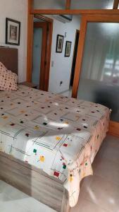 a bedroom with a bed with a comforter on it at Arena Maipú in Maipú