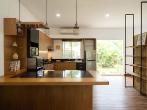 a kitchen with a large island in the middle at Zen Cove Villa - 5-Min Walk to Zen Beach, Srithanu in Haad Chao Phao