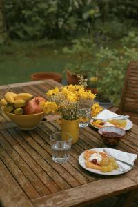 a table with a bowl of fruit and a plate of food at La Masia Costa Brava -Adults Only in Garrigás