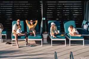 a group of people sitting on chairs on a patio at Villatel Orlando Resort in Orlando