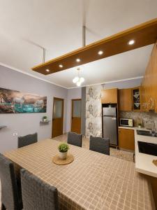 a kitchen and dining room with a table and chairs at Ledi’s Home in Borsh