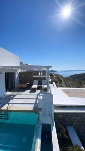 a villa with a swimming pool on top of a house at CIEL BOUTIQUE VILLAS in Afiartis