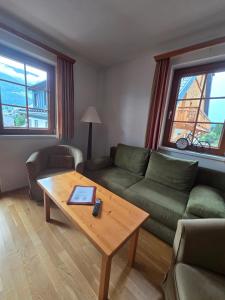 a living room with a couch and a coffee table at Stranach Appartements in Sankt Michael im Lungau