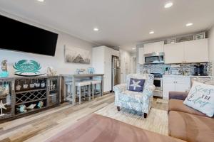 a living room with a couch a chair and a kitchen at HH Beach & Tennis 319B in Hilton Head Island