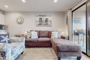 a living room with a couch and a chair at HH Beach & Tennis 319B in Hilton Head Island +42 photos