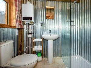 a bathroom with a sink and a toilet and a shower at 1 Bed in Chulmleigh oc-74133 in Eggesford +27 photos