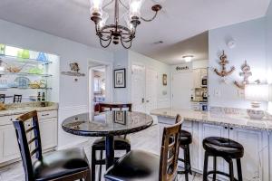 a kitchen with a round table and chairs at Fiddlers Cove 18B in Hilton Head Island