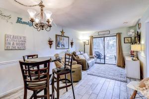 a kitchen and living room with a table and chairs at Fiddlers Cove 18B in Hilton Head Island