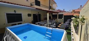 a swimming pool on the balcony of a house at Marcio's Home in Fernao Ferro