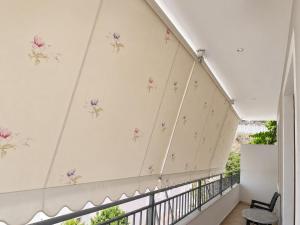 a balcony with flowers on the wall at Ledi’s Home in Borsh