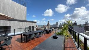 a balcony with tables and chairs on a building at Acqua Tambaú Luxury Flat 100 meters from the sea in João Pessoa