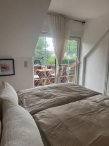 a bedroom with a large bed and a window at Haus David in Erfurt