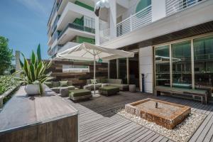 a patio with a bench and an umbrella at AmbientHotels Panoramic in Rimini