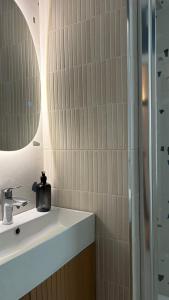 a bathroom with a sink and a shower at Bed & Bricks in Reggio Emilia +7 photos