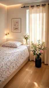 a bedroom with a bed and a window with flowers at House in Obernai in Obernai