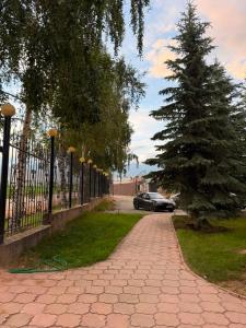 a car parked next to a fence with a christmas tree at Barskhan Guest House in Bosteri