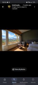 a bedroom with a bed and a view of a room at Hotel Royal EdelWeiss in Leh +7 photos