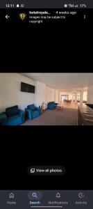 a picture of a living room with blue couches at Hotel Royal EdelWeiss in Leh