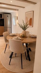a dining room table with chairs and a vase on it at House in Obernai in Obernai +16 photos