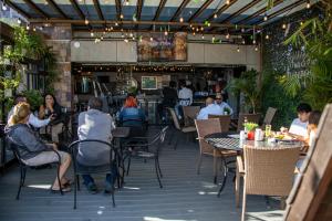 a group of people sitting at tables in a restaurant at Hotel Velario in Tijuana