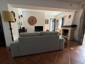 a living room with a couch and a fireplace at Paco d'Anha in Viana do Castelo
