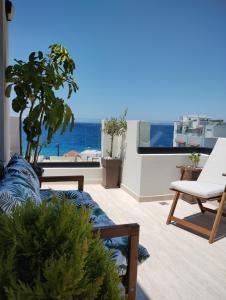 a living room with a couch and a view of the ocean at Biliaba in Rhodes Town
