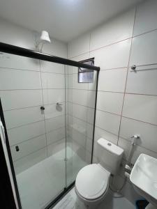 a bathroom with a shower and a toilet and a sink at Hotel Brisa Serrana no Centro de Serrinha in Serrinha