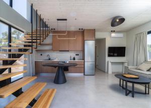a kitchen and living room with a spiral staircase at Avelia Villa Tsoukalades in Tsoukalades
